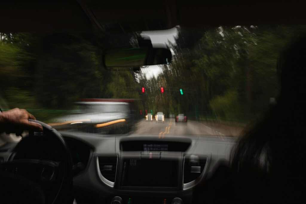 View from the driver’s seat of a car moving through traffic, with the road ahead blurred