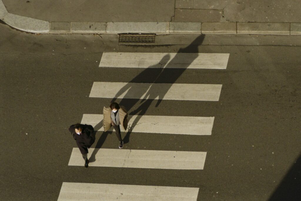 Two people walking across a city crosswalk