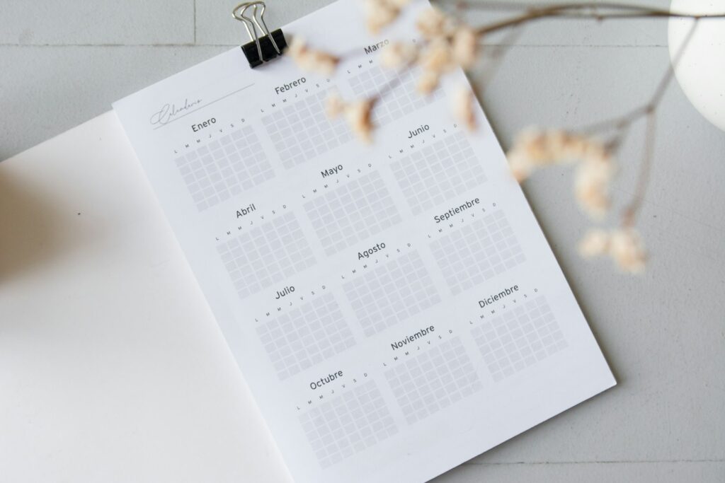 An open planner showing a blank monthly calendar page