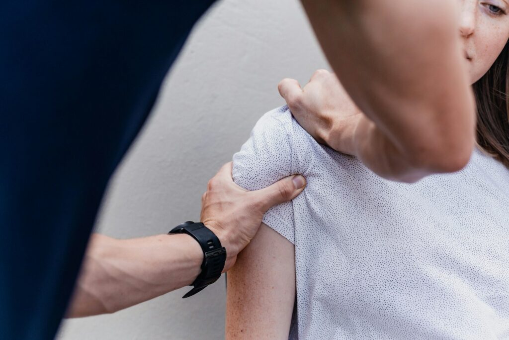 A therapist treating a patient's shoulder